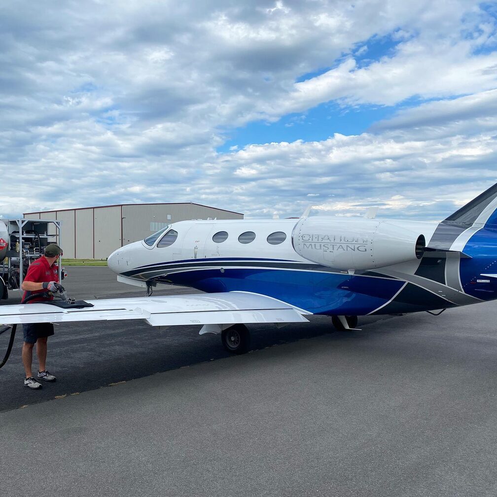 Elite Aircraft Services ground crew fueling a Cessna Citation Mustang private jet on the ramp