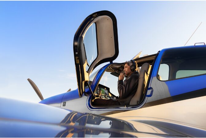 Elite Aircraft Services pilot in the cockpit at sunset, ready for a flight lesson