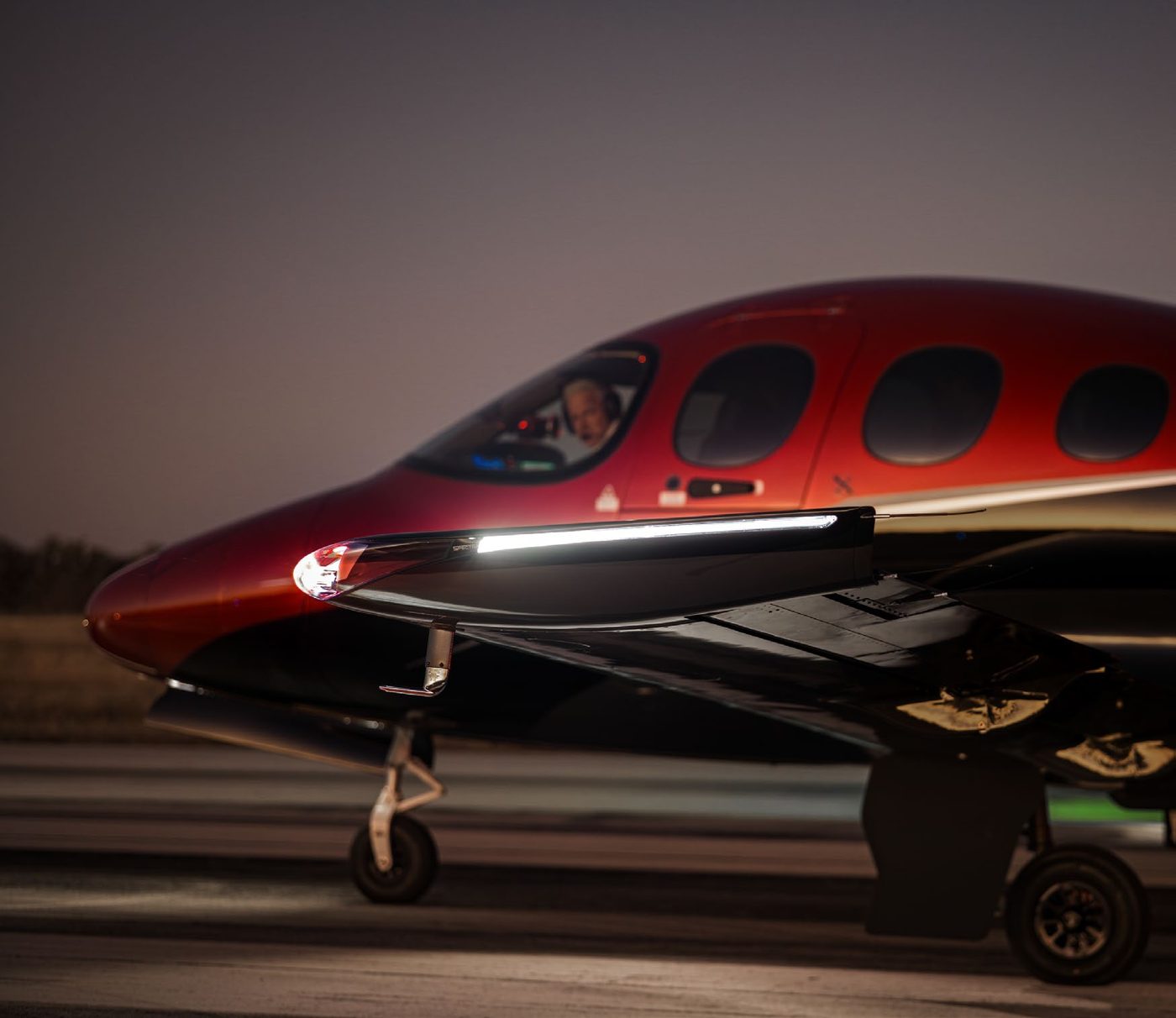 Elite Aircraft Services SF50 Vision Jet taxiing at dusk with pilot visible in the cockpit