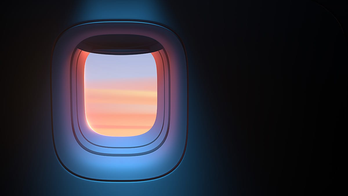 View from an aircraft cabin window at sunset